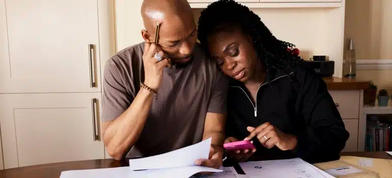 husband and wife calculating How much does an international move cost