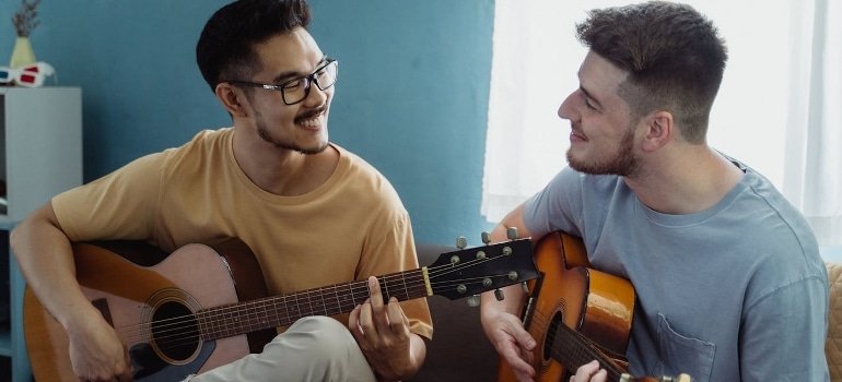 roommates playing guitars
