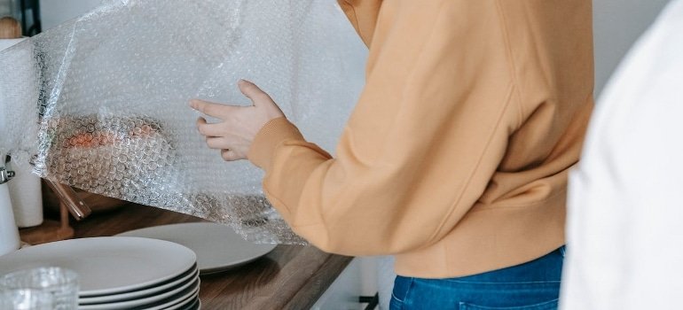 woman wrapping and shipping fragile items overseas