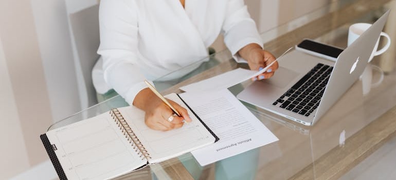 A person filling out a paper for hiring ocean freight companies