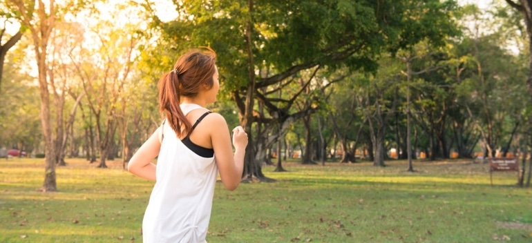 Person running through a park.