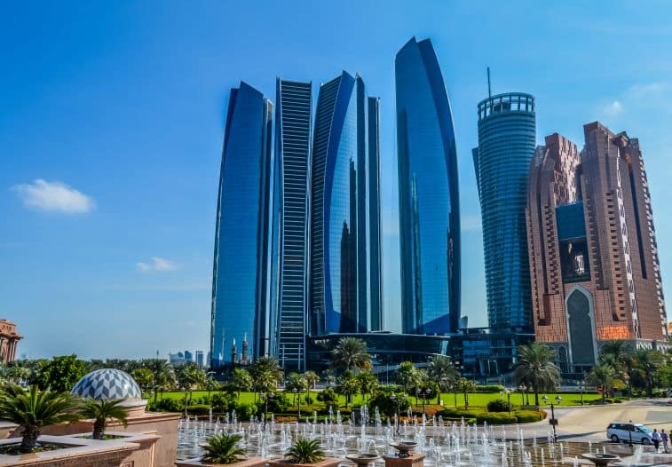 Skyscrapers in Abu Dhabi, UAE, surrounded by greenery, highlighting the city's blend of modern architecture and natural beauty.