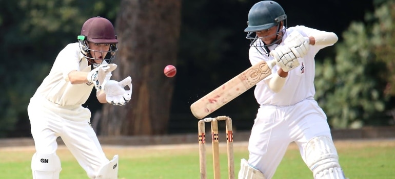 two men playing cricket 