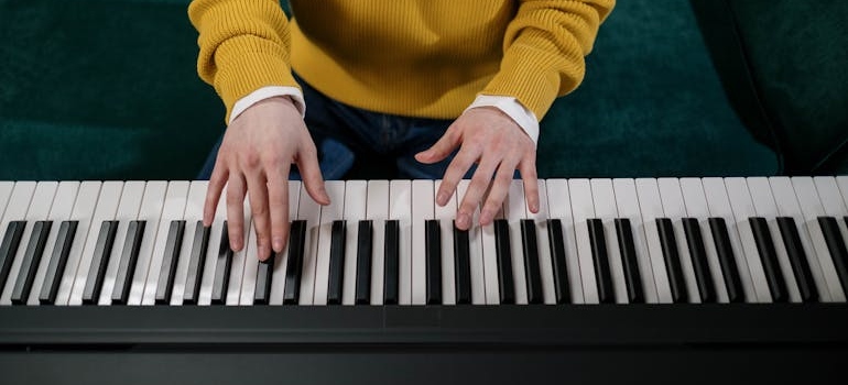 a man playing a piano before hiring international piano movers