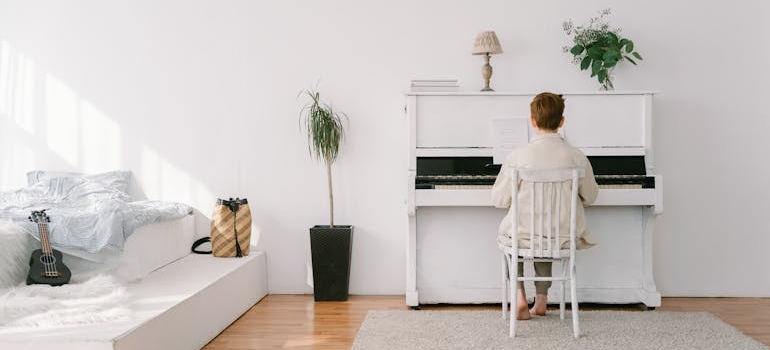 a man playing a white piano 