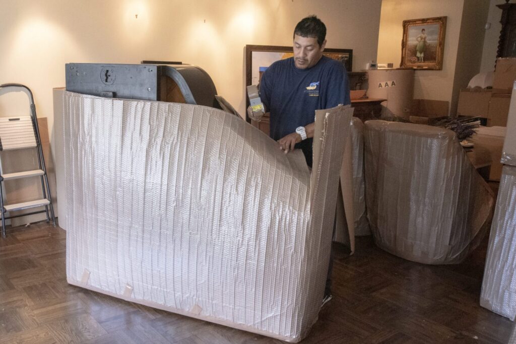 mover wrapping a piece of furniture