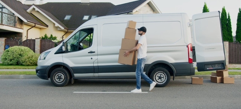 a man moving to Portugal carrying boxes