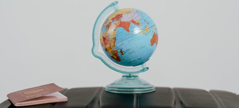 a passport and a globe on the table