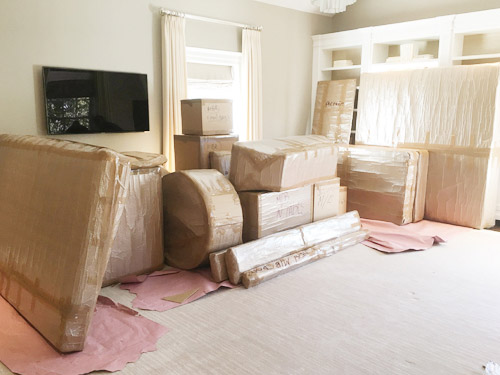 a living room with packed boxes