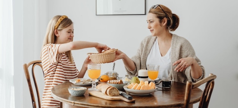 a woman Raising a Family in France having breakfast with her daughter 