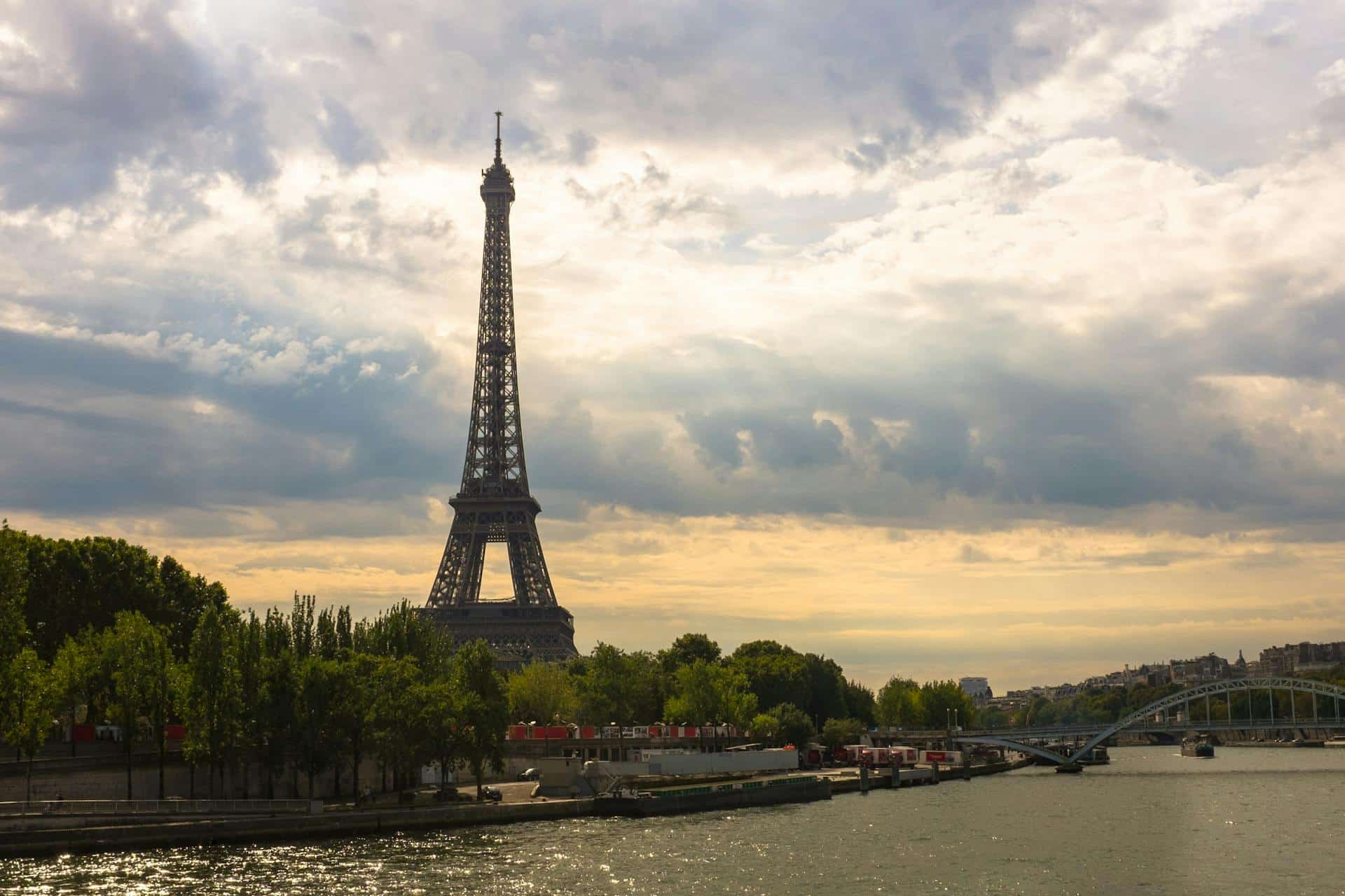 a photo of a river and the eiffel tower