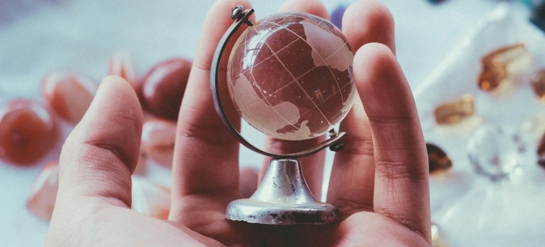 Hand holding a globe 