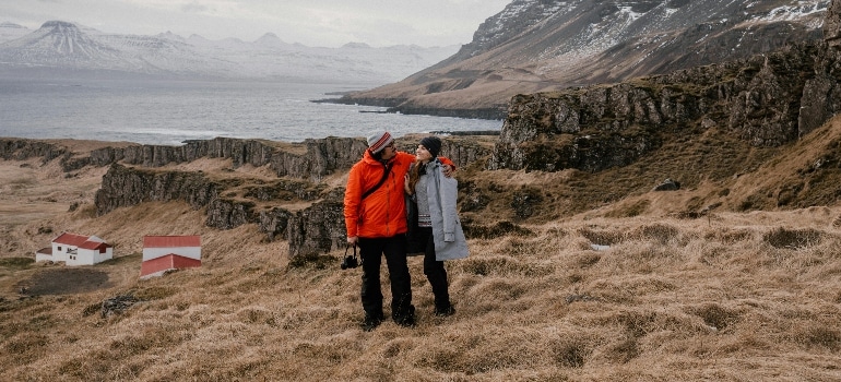 A Couple Standing on a Hay Field Embracing the Nordic Lifestyle